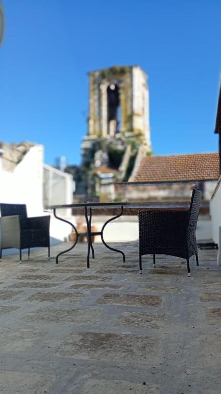 a table and chairs with a building in the background at Old Town in Castellana Grotte