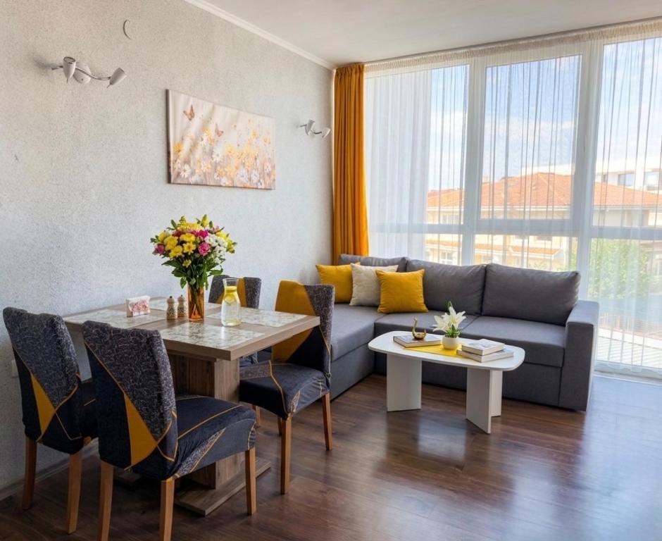 a living room with a couch and a table at Sunset Apartment Atlantis Resort in Burgas