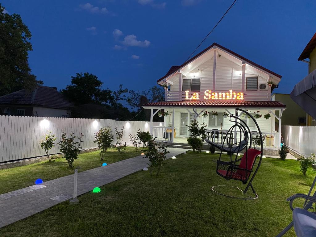 a house with a playground in the yard at night at La samba in Crisan