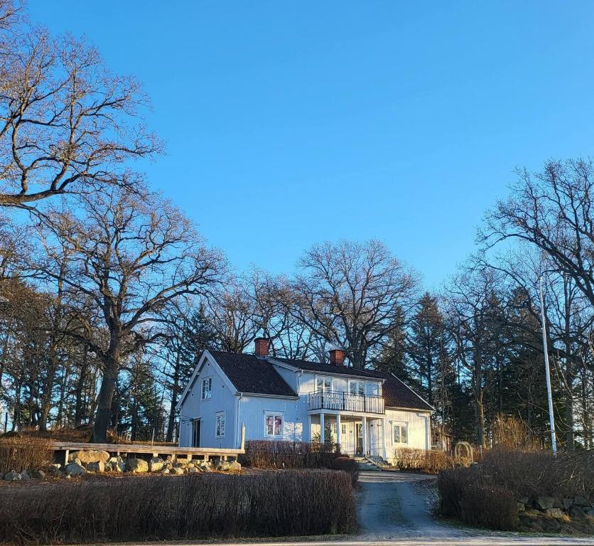 a large white house in front of some trees at Safety System Show Jumps in Enköping