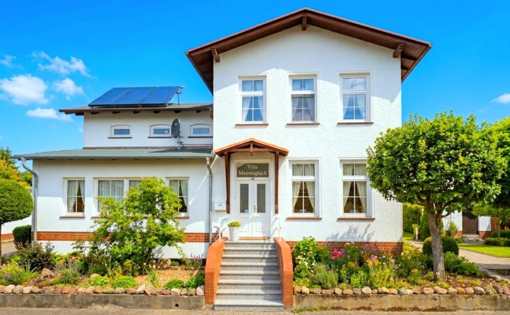 a white house with solar panels on it at Komfortfewo Meeresleuchten in Sassnitz