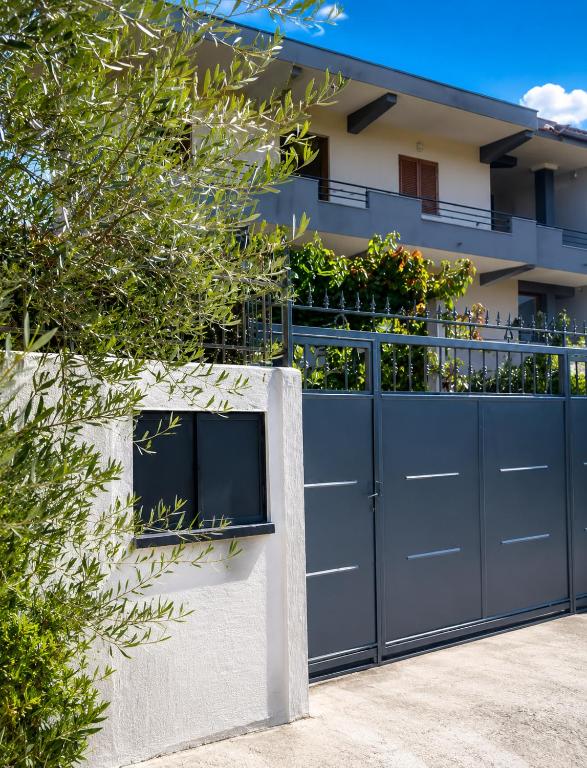 a blue gate in front of a house at Guest House Emi in Berat