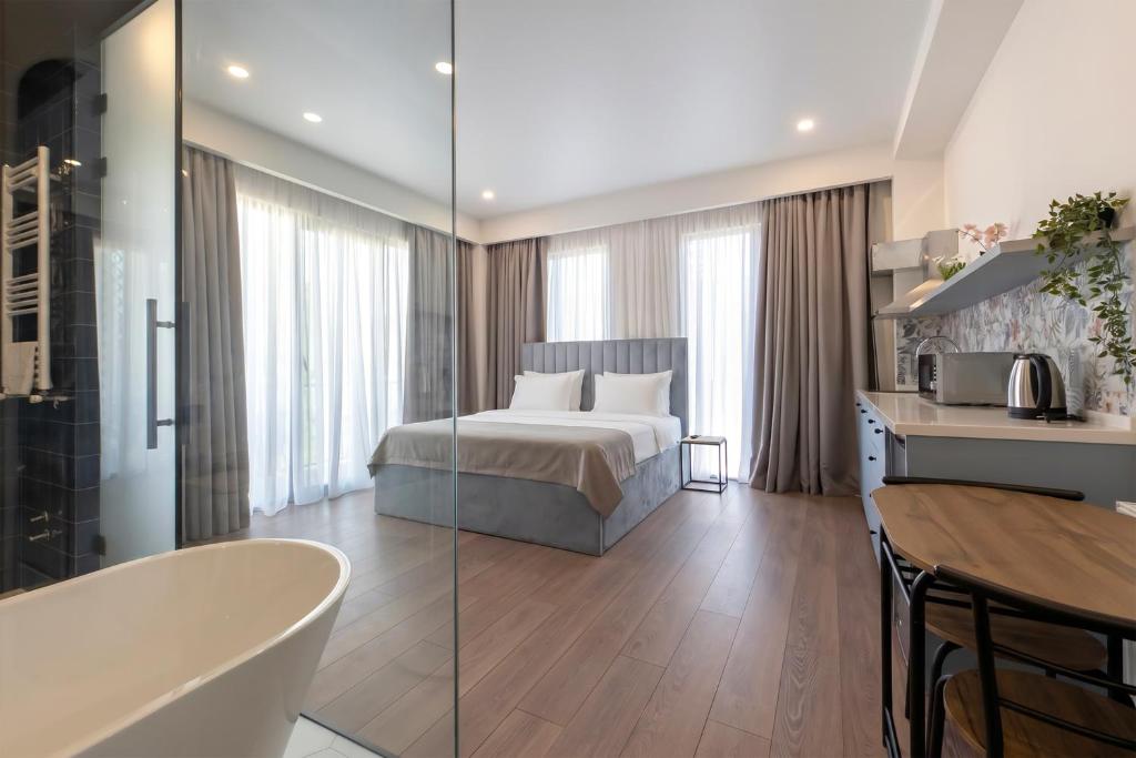a hotel room with a bed and a bath tub at M&N Hotel in Tbilisi City