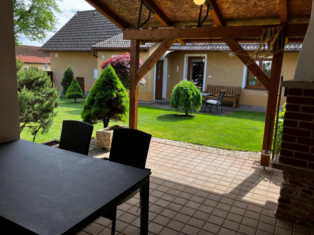 a patio with a table and chairs in a yard at Chalupa Marie in Radimovice u Želcě
