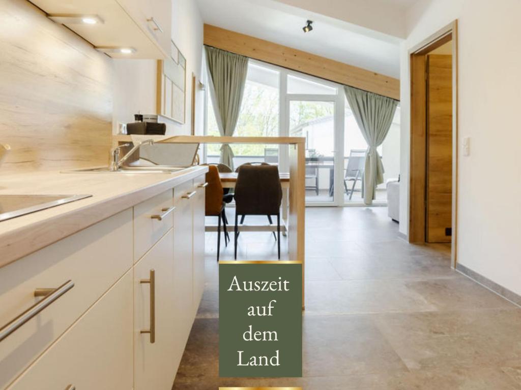 a kitchen with a table and a dining room at Heeser Hof - Natururlaub direkt am Nationalpark Maasduinen - Natur & Rad & Wanderwege ab Hof - Auszeit auf dem Land - Hunde willkommen in Weeze