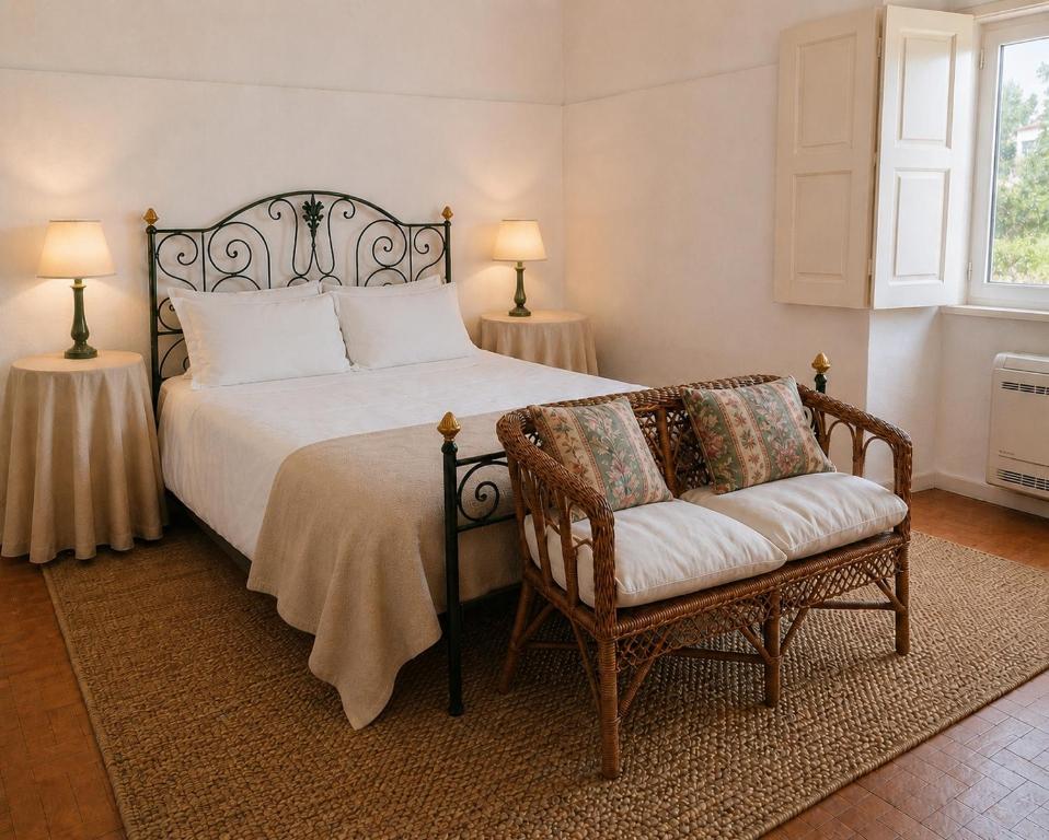 a bedroom with a bed and a chair and a window at Quinta Farm Stay - Silence and Nature Retreat in Lousã