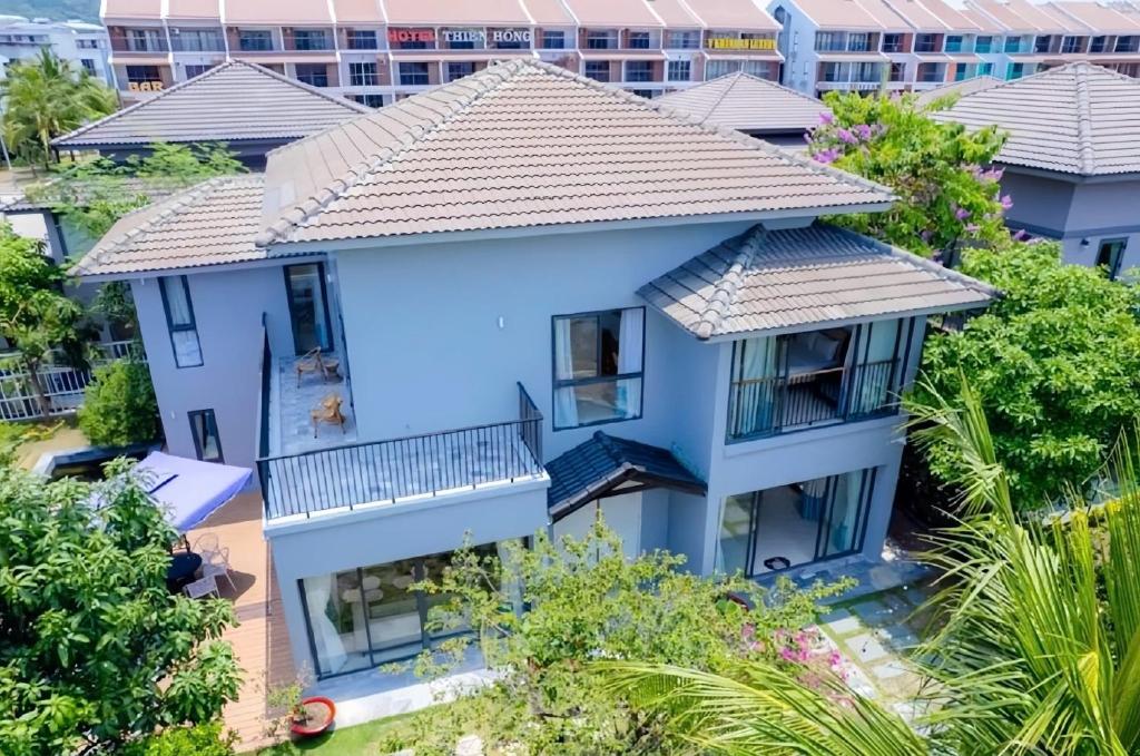 an aerial view of a blue house with trees at Nova Villas Phu Quoc in Phú Quốc