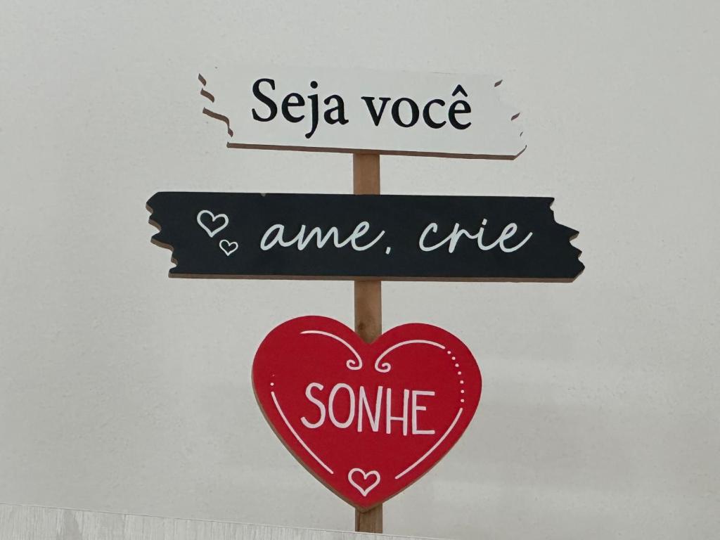 a sign with two street signs and a heart at Ar Doce in Portel