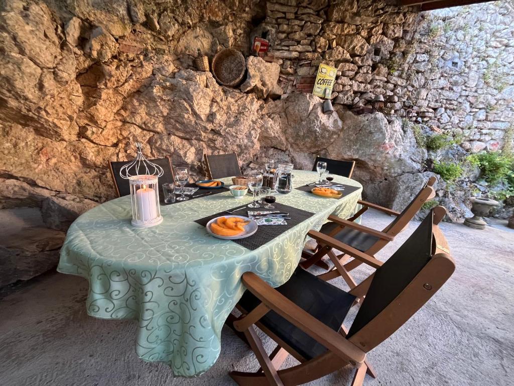 a table with food on it in a stone room at Chambre d'Hôtes les 3 Cochons d'Olt in Arcambal