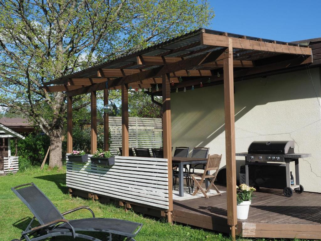 a pergola with a grill on a deck at Villa Virtala Lohja in Lohja