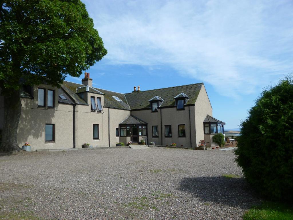 a large white house with a large driveway at Monturpie Guest House in Kirkton of Largo