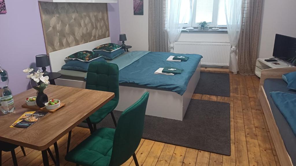 a bedroom with a bed and a table and a couch at Ubytovaní U Dvora in Bohumín