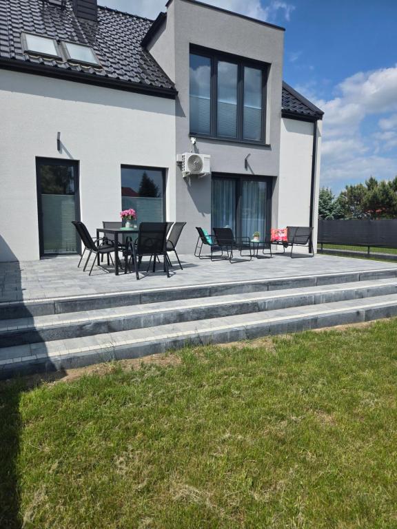 a patio with a table and chairs on a house at Akacjowa 11 in Skorochow