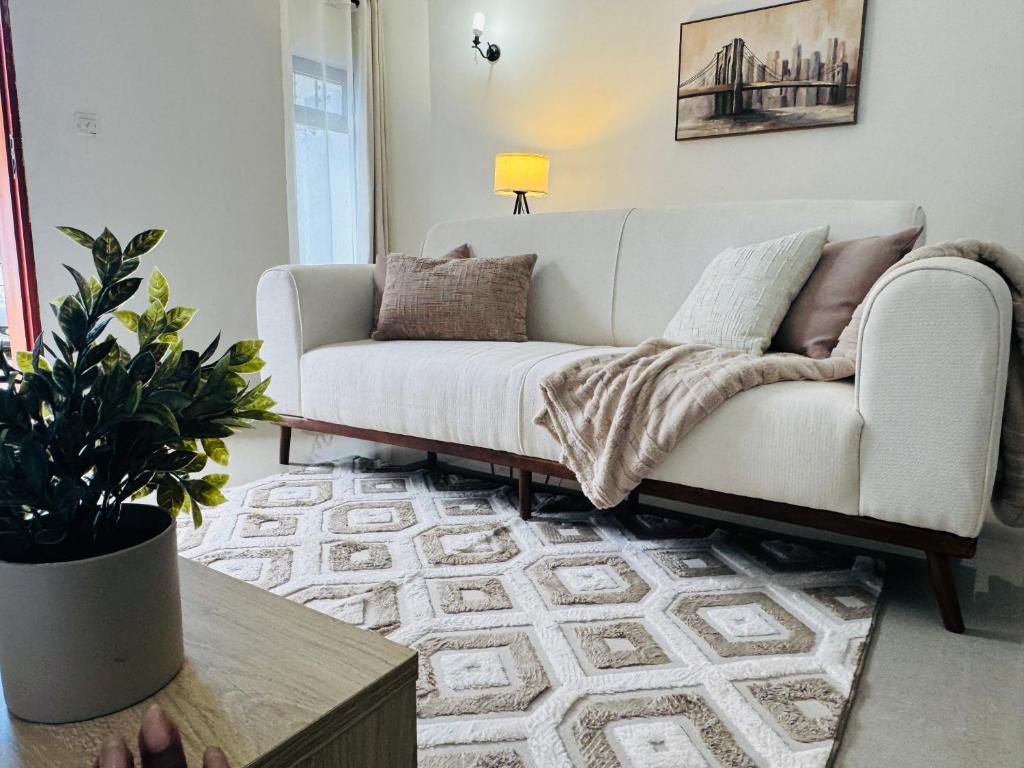a living room with a couch and a table at Revo Apartments in Lusaka