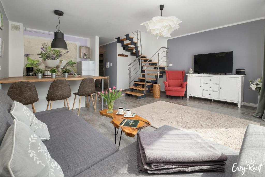 a living room with a couch and a table at Piastowska in Pobierowo