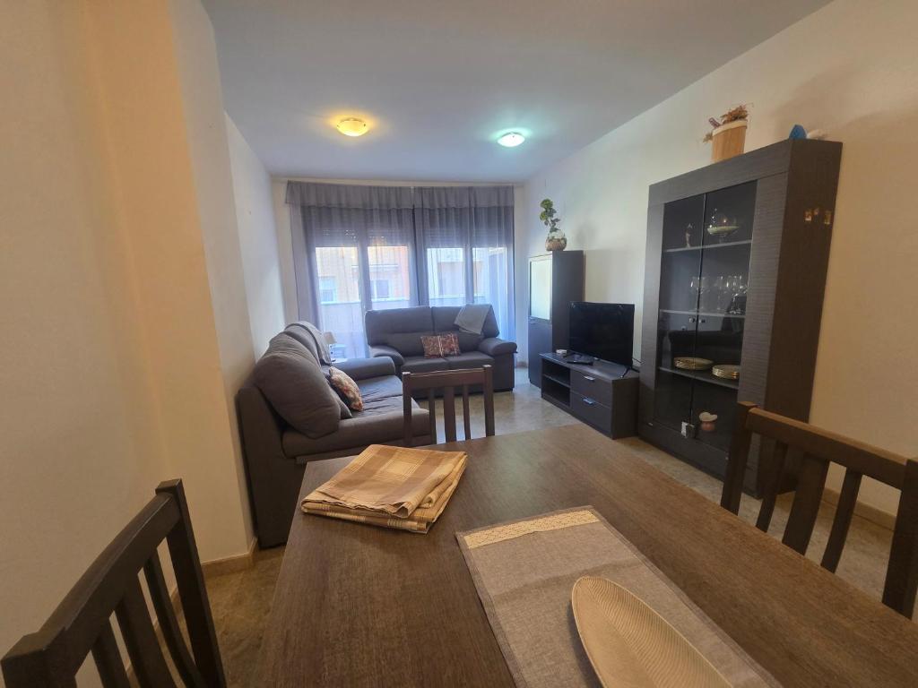 a living room with a couch and a table at APARTAMENTO CONSTITUCIÓN in Benicarló