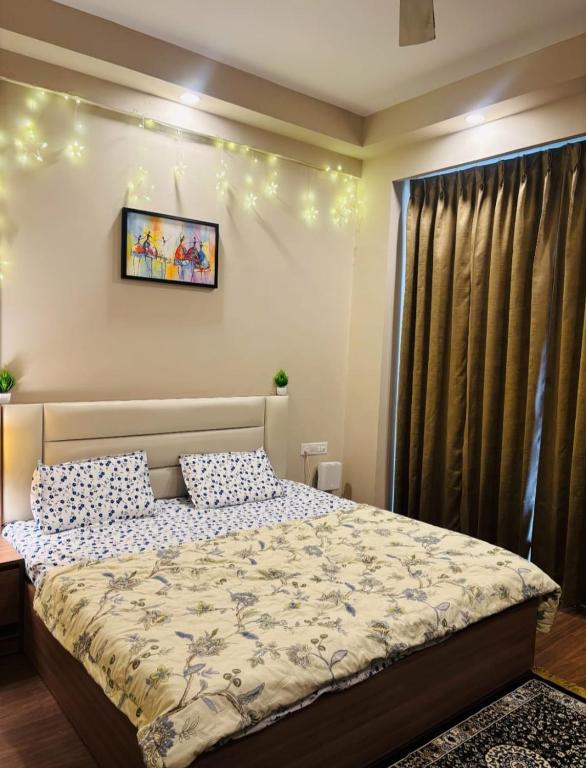 a bedroom with a bed and a picture on the wall at Apex Hub in Greater Noida