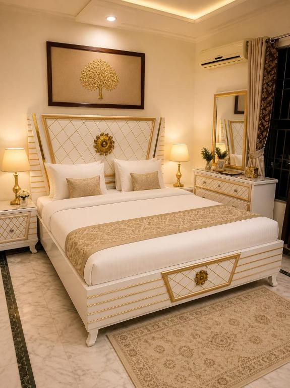 a bedroom with a large bed and two night stands at Grand Residency Guest House in Islamabad