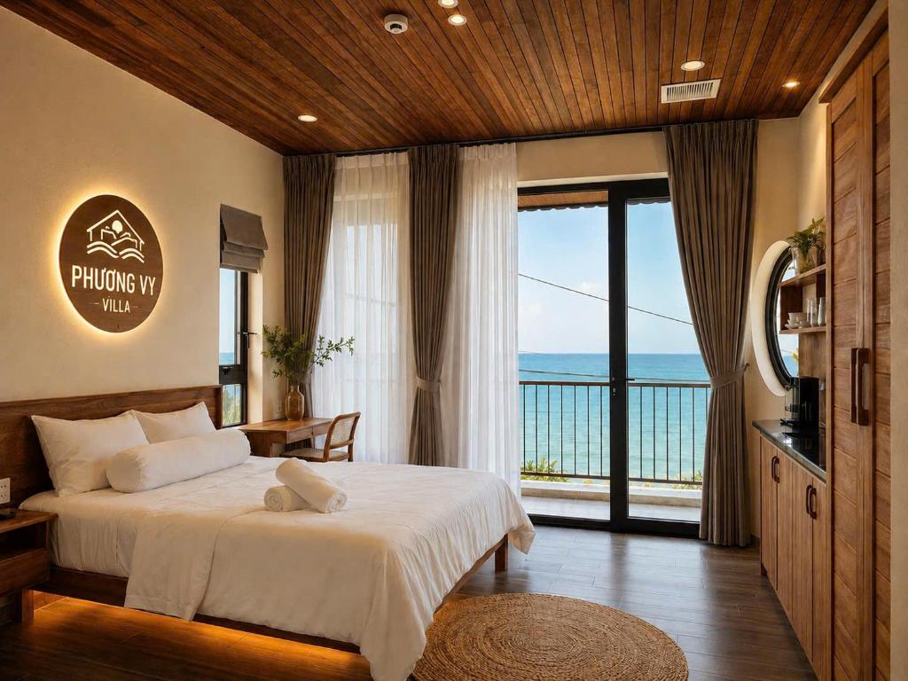 a bedroom with a bed with a view of the ocean at Phuongvilla Đông Hải in Thôn Ðông Giang