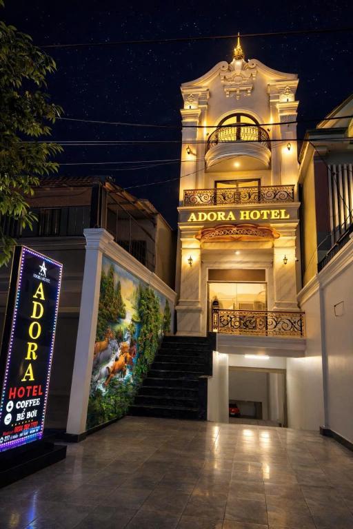 a building with a sign in front of it at night at Adora Hotel Khe Sanh in Khe Sanh