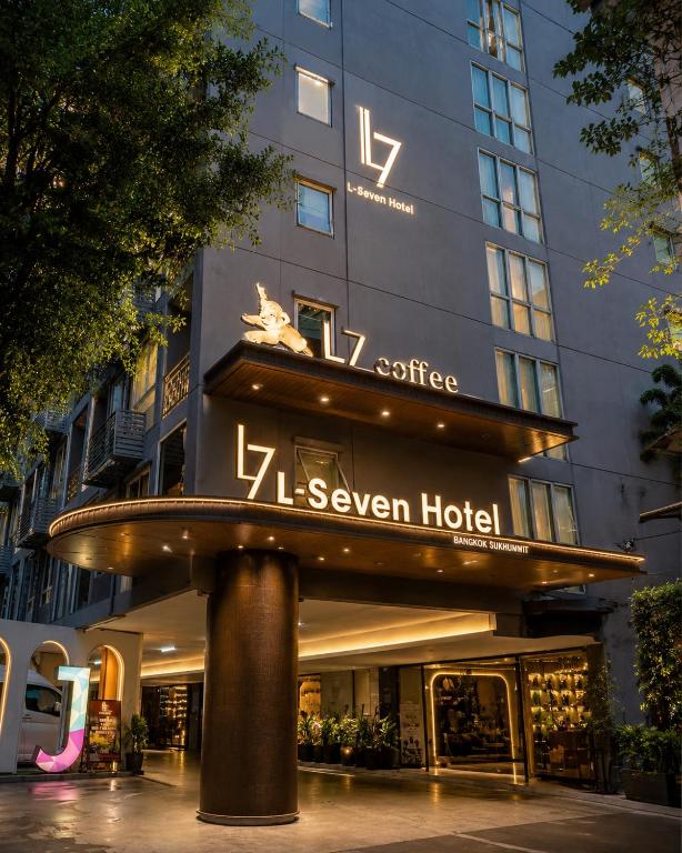a building with a sign that reads seven eleven hotel at L-Seven Hotel in Bangkok