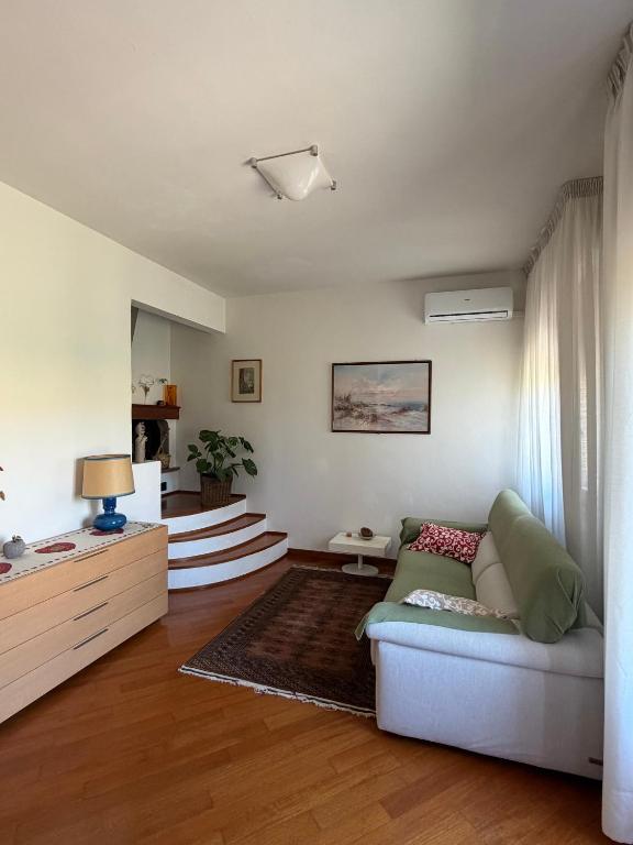 a living room with a couch and a table at Casa Dandelle in Gambassi Terme