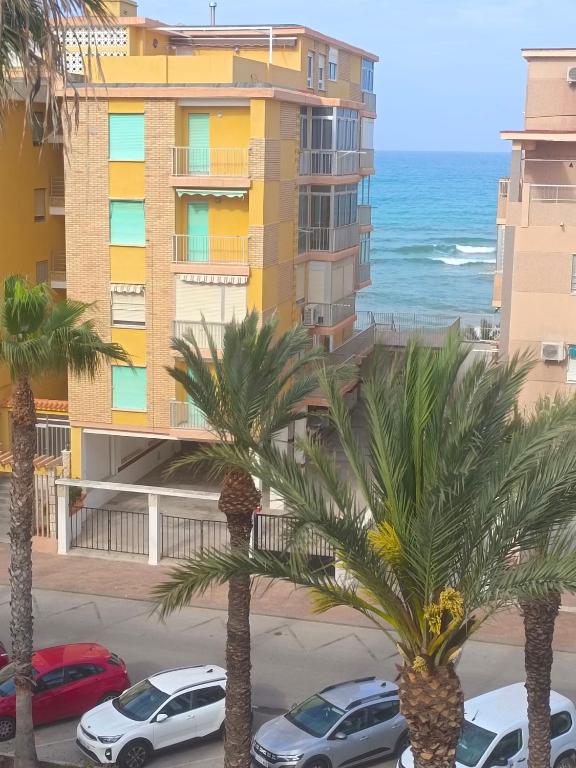a view of the ocean from the balcony of a building at Marina Tavernes in Tavernes de Valldigna
