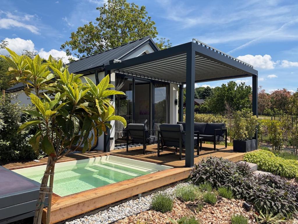 a pavilion with a pool in a garden at Lavendream in Kőröshegy