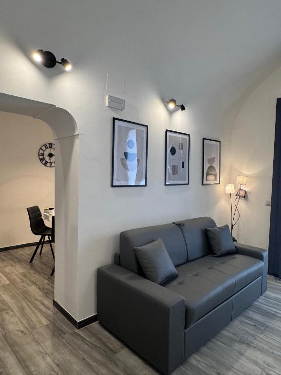 a living room with a couch and a table at Norcia Stylish Apartment in Norcia