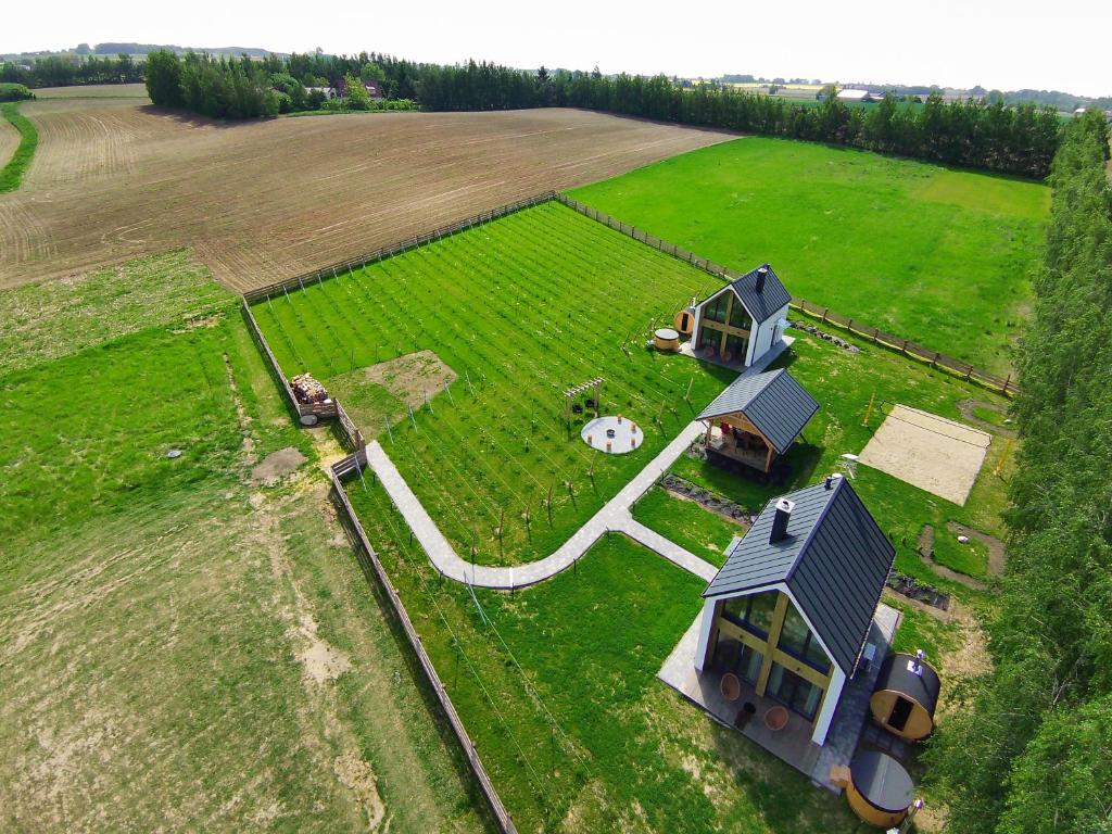 an aerial view of a small house in a field at Winnica Osada Moszczonne in Moszczonne