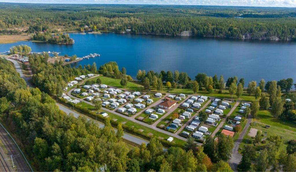 an aerial view of a parking lot next to a lake at Sommens Camping in Sommen