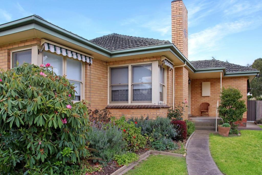 a home with a brick house at Retro Retreat in Highton