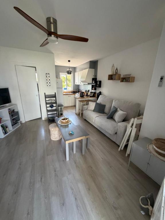 a living room with a couch and a table at La Guapa in Cala en Porter