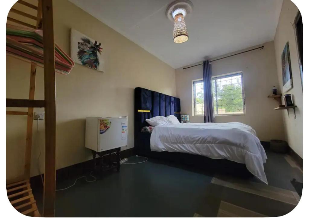 a bedroom with a large bed and a window at Iringa Hillside backpackers in Iringa