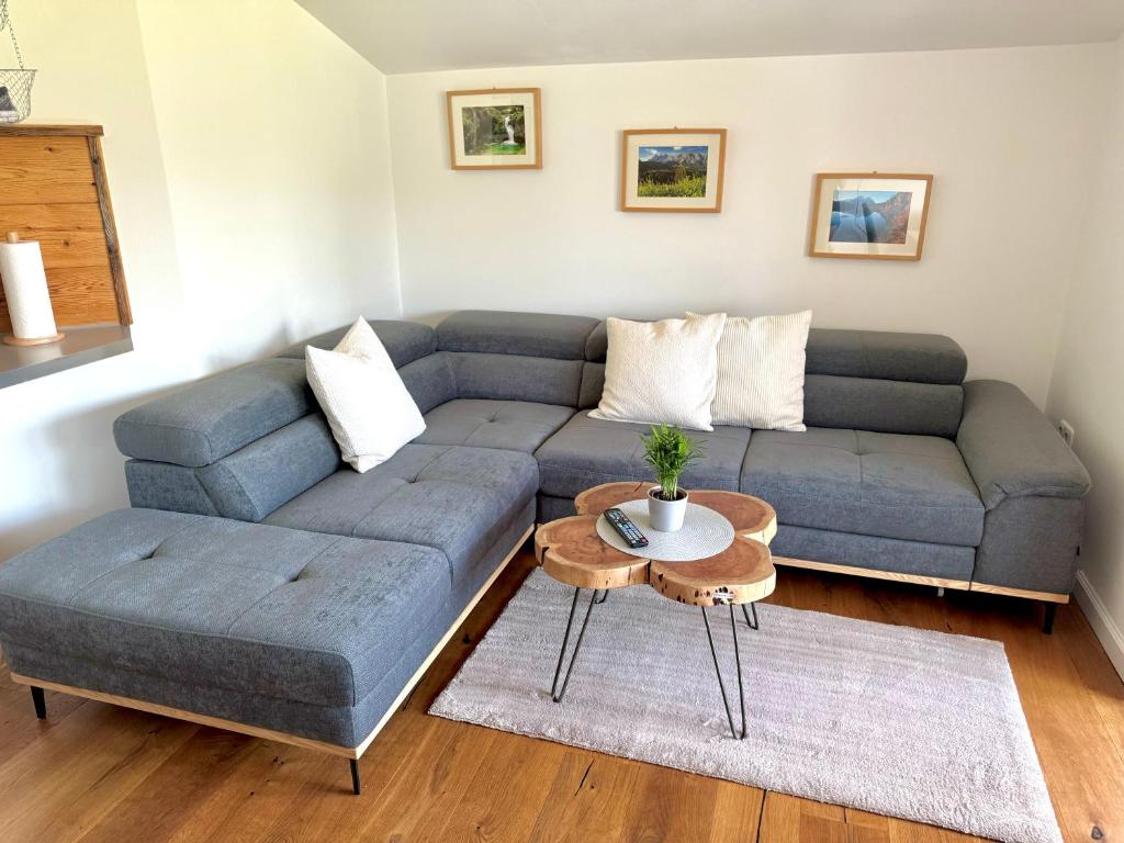 a living room with a blue couch and a table at Haus Landzauber in Ramsau am Dachstein