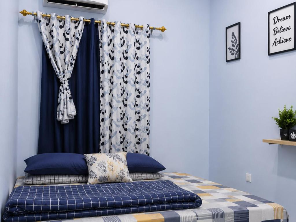 a bed in a room with a curtain at Bkc Home's 101 in Mataram