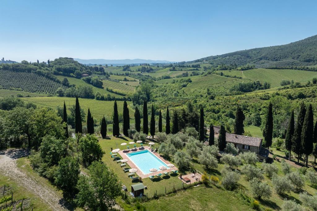 an aerial view of a villa with a swimming pool and trees at Podere le Lune with Pool, San Gimignano in San Gimignano