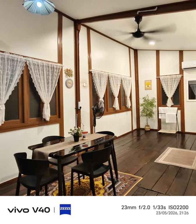 a living room with a dining room table and chairs at Ciao Bella in Dungun