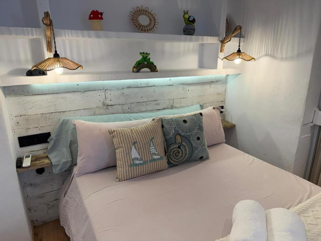 a bed with two pillows on it in a room at Puerto de Jávea in Jávea