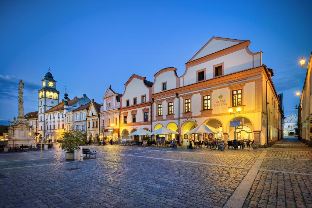 a city street with a clock tower in the background at Wellness Hotel Zlatá Hvězda in Třeboň