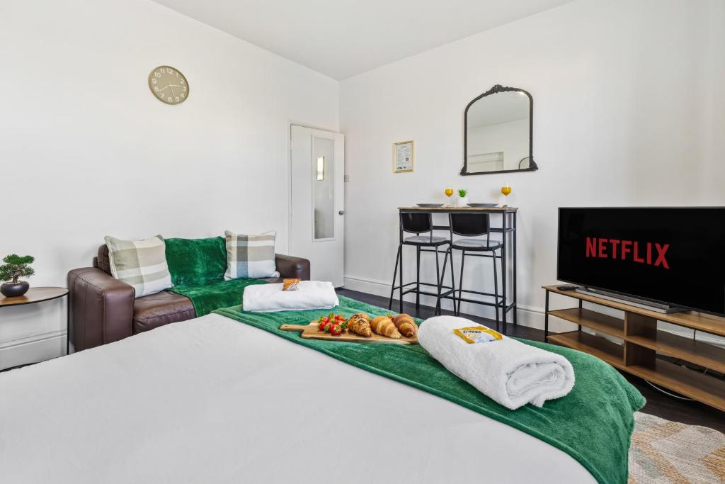a hotel room with a bed and a television at Nile - Cosy Studio Apartment by Traboule Properties Ltd in Warrington