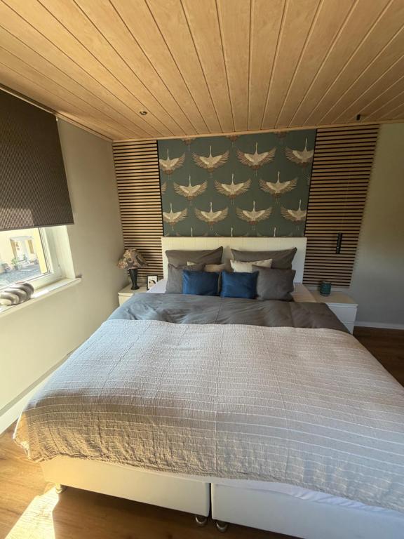 a bedroom with a large bed with a wooden ceiling at Bella's Eden in Grimma
