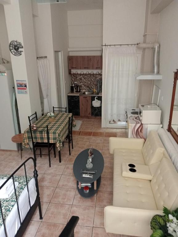 a living room with a couch and a table at Studio Panagiota in Kavála