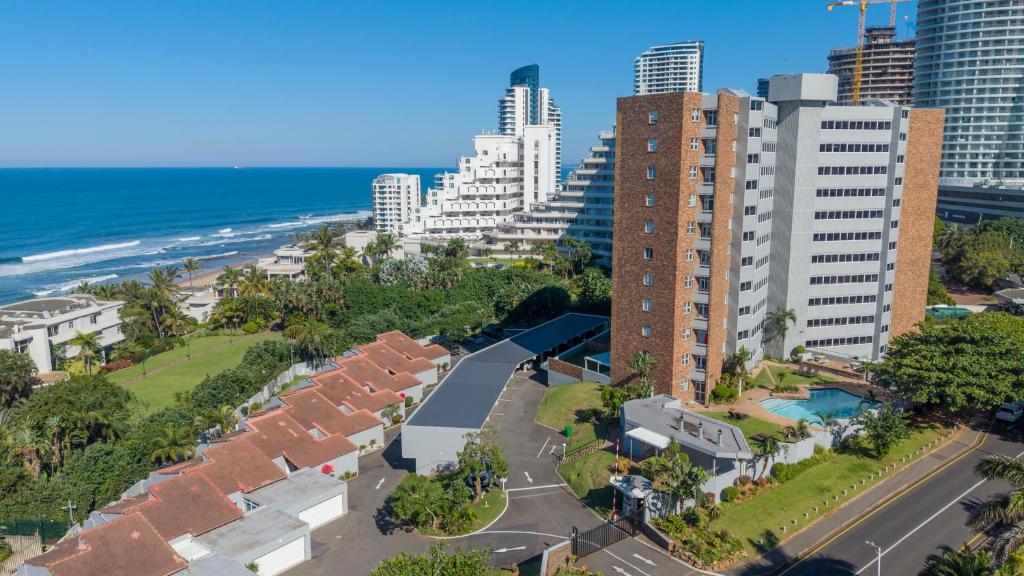 an aerial view of a city with buildings and the ocean at D3 Sea Lodge - by Stay in Umhlanga in Durban