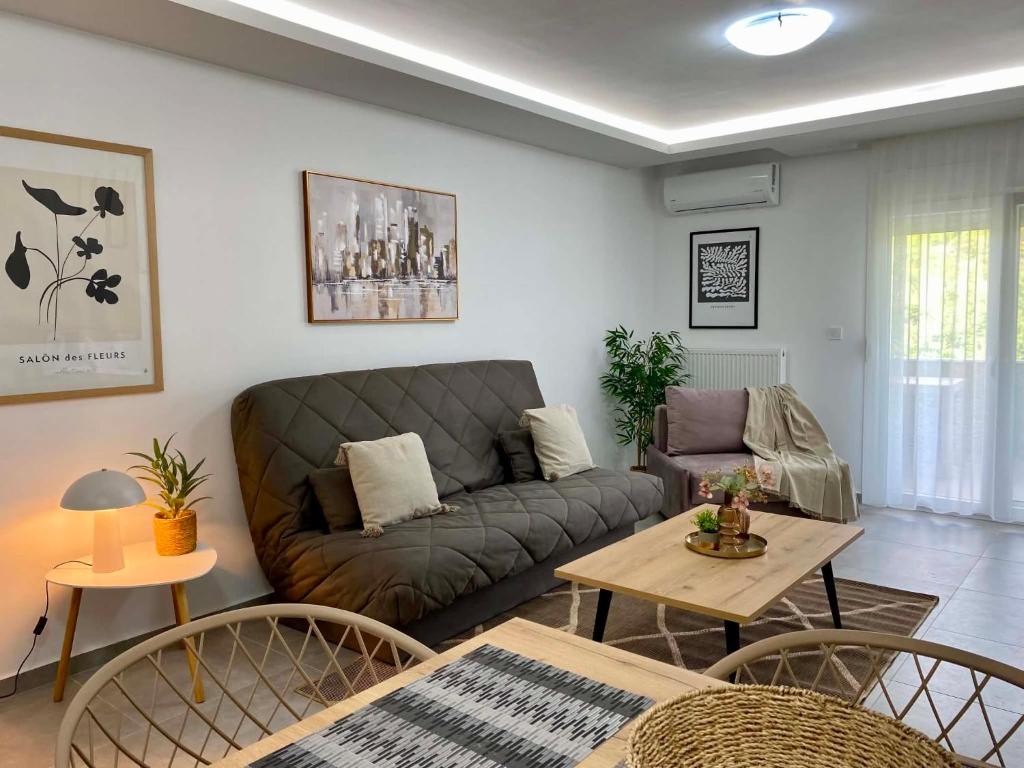 a living room with a couch and a table at Margarita's apartment 4 in Nea Peramos