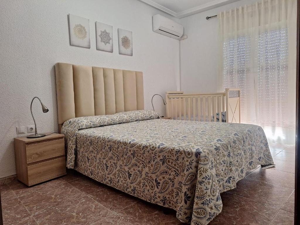 a bedroom with a bed and a nightstand and a bed sidx sidx sidx sidx at Apartamento Sevilla 3 in La Guardia