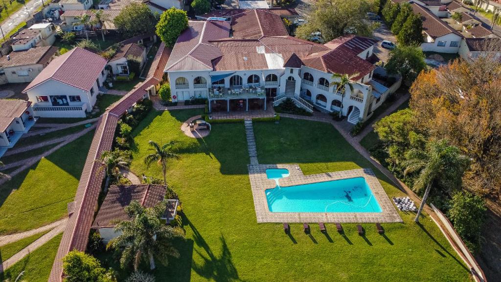 an aerial view of a house with a swimming pool at Mountain View International Hotel - Eswatini in Mbabane