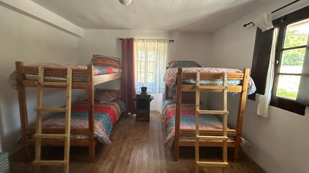 a bedroom with two bunk beds and a window at Gaia Merindades in Salinas de Rosío