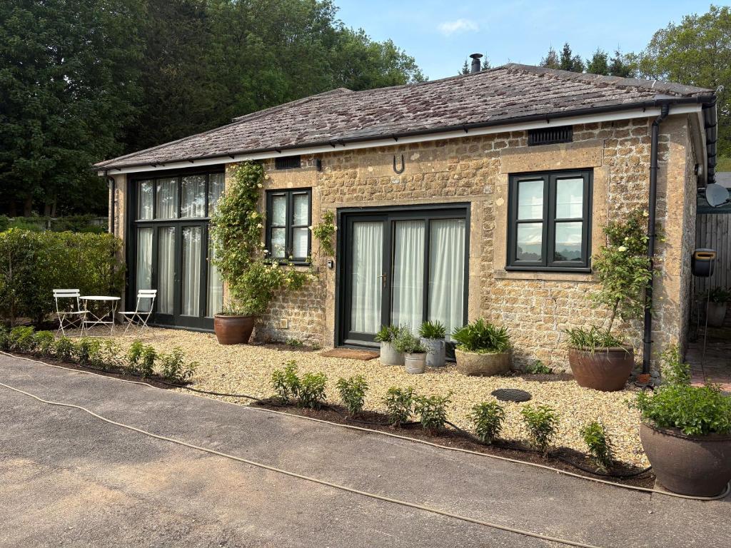 a brick house with plants in front of it at The Stables in Corsley