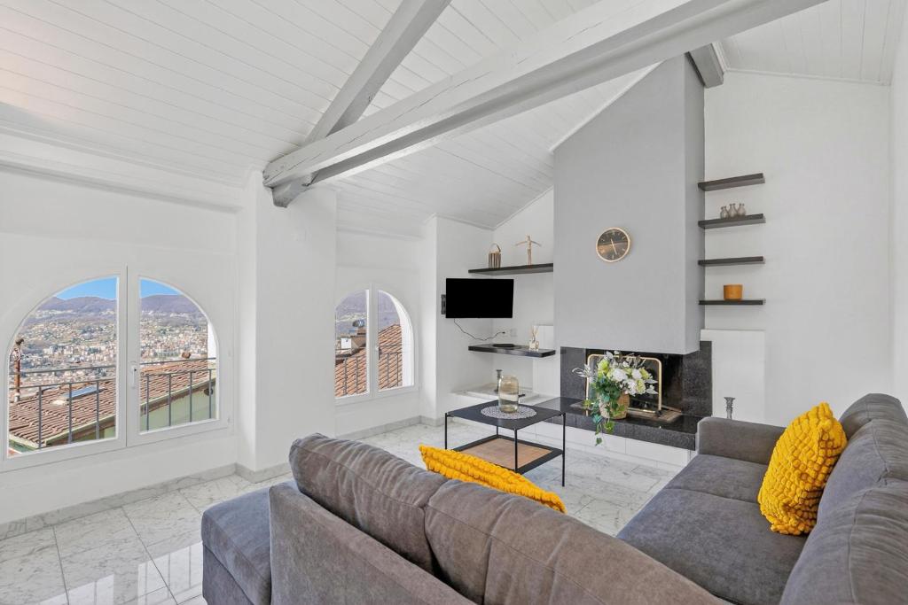 a living room with a couch and a fireplace at Charm Apartments Aldesago in Aldesago